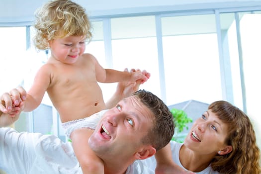 High key portrait of nice young family getting busy