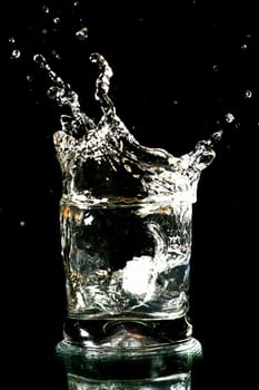 alcohol splash on black background close up