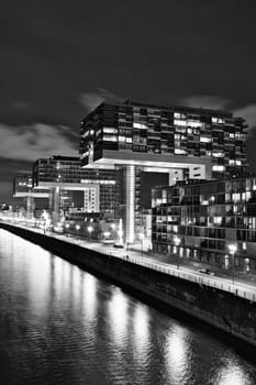 Aerial view of illuminated crane houses by the canal at the Zollhafen in Cologne, Germany at night