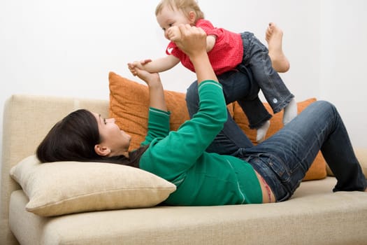 happy family playing on sofa