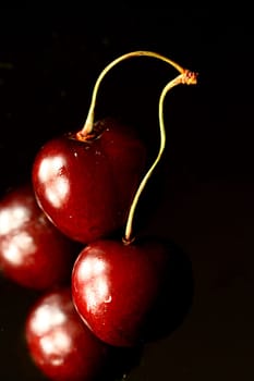 red pulpy cherry on black