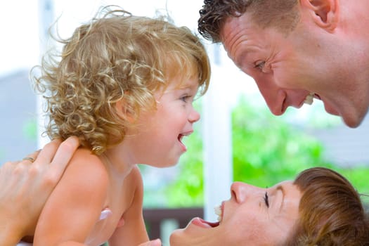 High key portrait of nice young family getting busy