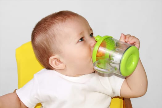 One-year-old baby is drincking water..