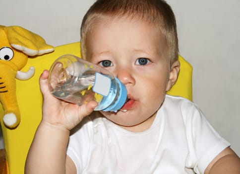 One-year-old baby is drincking water..