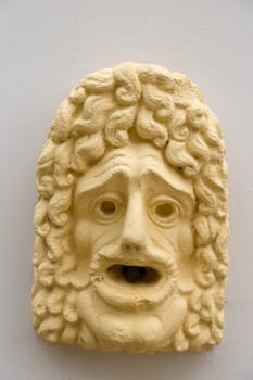 Yellow mask on a fountain