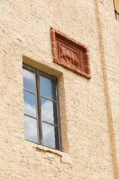 Windows and cattle relief on a stable facade