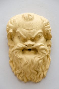 Yellow mask on a fountain