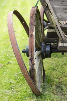 Old horse-drawn carriage with expired tyre off the wheel