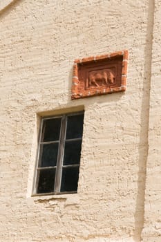 Windows and cattle relief on a stable facade