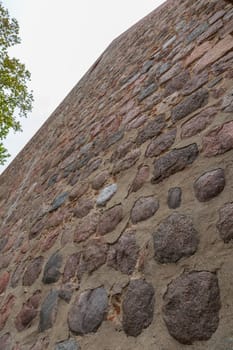Stone wall with natural stones on an old building