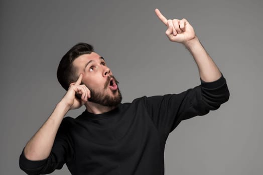 Eureka. man with an idea raising his finger in the air on gray background