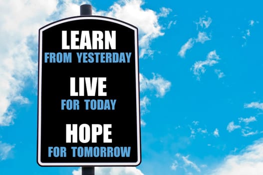 LEARN FROM YESTERDAY, LIVE FOR TODAY, HOPE FOR TOMORROW  motivational quote written on road sign isolated over clear blue sky background with available copy space. Concept  image