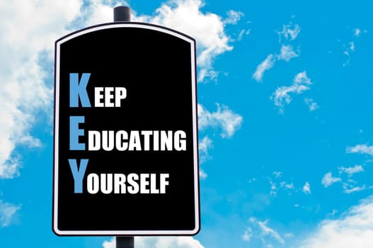 KEY as KEEP EDUCATING YOURSELF  motivational quote written on road sign isolated over clear blue sky background with available copy space. Concept  image