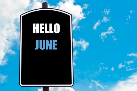HELLO JUNE motivational quote written on road sign isolated over clear blue sky background with available copy space. Concept  image