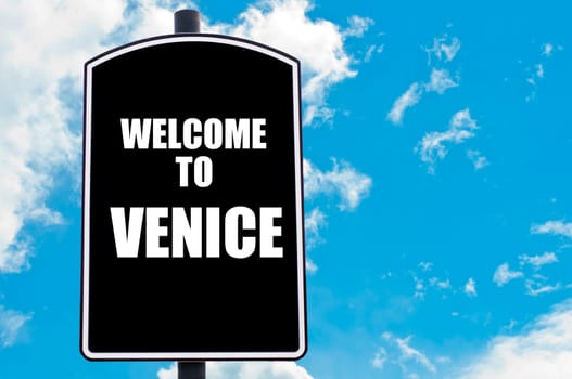 Black road sign with greeting message WELCOME TO VENICE isolated over clear blue sky background with available copy space. Travel destination concept  image