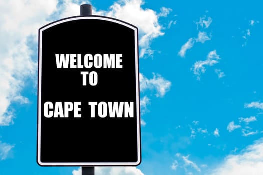 Black road sign with greeting message WELCOME TO CAPE TOWN isolated over clear blue sky background with available copy space. Travel destination concept  image