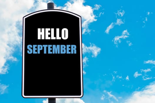 HELLO SEPTEMBER motivational quote written on road sign isolated over clear blue sky background with available copy space. Concept  image