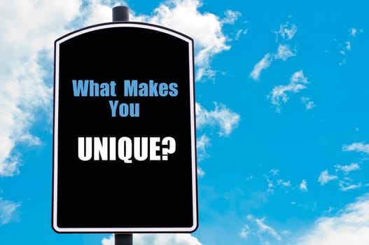 WHAT MAKES YOU UNIQUE  motivational quote written on road sign isolated over clear blue sky background with available copy space. Concept  image