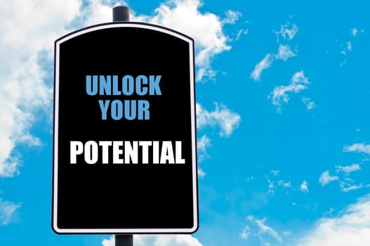 UNLOCK YOUR POTENTIAL motivational quote written on road sign isolated over clear blue sky background with available copy space. Concept  image