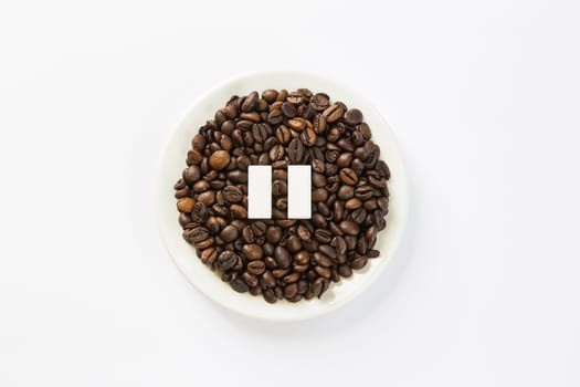 Concept of a coffee pause, coffee beans arranged in a circle with sugar cubes.