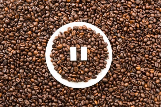 Concept of a coffee pause, coffee beans arranged in a circle with sugar cubes.