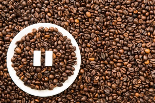 Concept of a coffee pause, coffee beans arranged in a circle with sugar cubes.