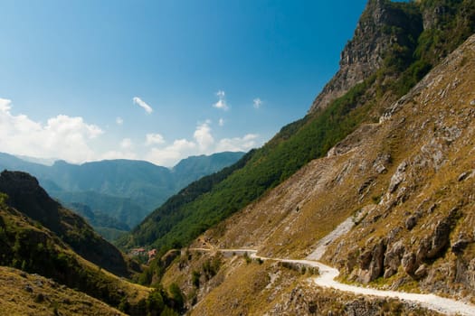 Ancient road in the valley below a cliff