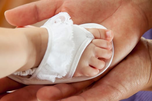 Mom holding the foot with tenderness