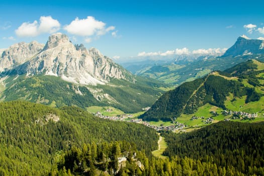 Green valley with the village of Corvara in the dolomities
