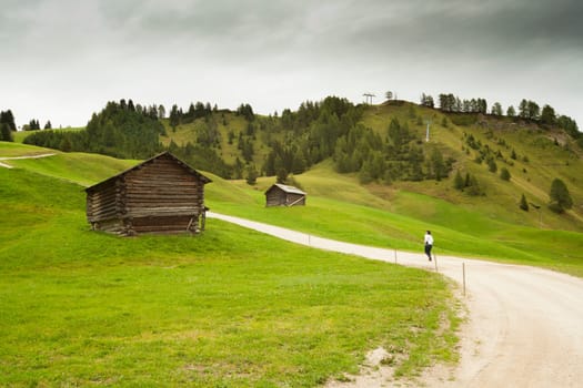 Woman walking along a mountain path alone