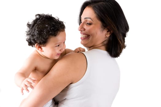 An east indian mother smiles as she holds her baby
