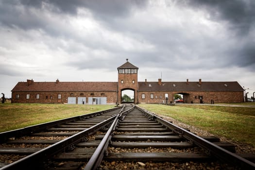 Railroad track to main gate of Auschwitz former German concentration and extermination camp in Poland