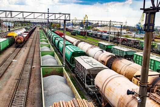 Train carriages for the transportation of goods on railways. Rail transportation. Iron rails. Industrial transport. Train carriage. Transport business. Railway depot. Transport interchange.