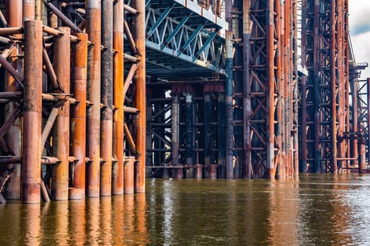 Reinforced concrete structure of the bridge under construction. Bridge over the Dnieper River in Kiev. Engineering structure. Building construction. Water crossing. Industry. Ukraine.