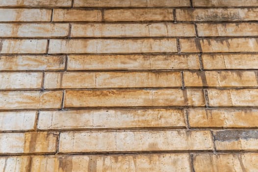The texture of the wall of concrete blocks with traces of rust. Block concrete wall. Rust streaks. Industrial construction. View from bottom to top. Aging process. background image.