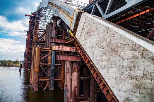 Reinforced concrete structure of the bridge under construction. Bridge over the Dnieper River in Kiev. Engineering structure. Building construction. Water crossing. Industry. Ukraine.