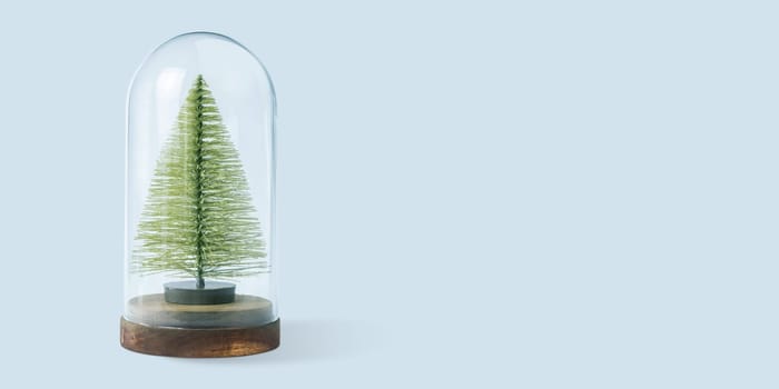 Christmas winter festive ornament. Christmas tree in glass dome. Christmas holiday party decoration. Minimal holiday greeting season. Merry Christmas and Happy New Year. Panoramic banner.