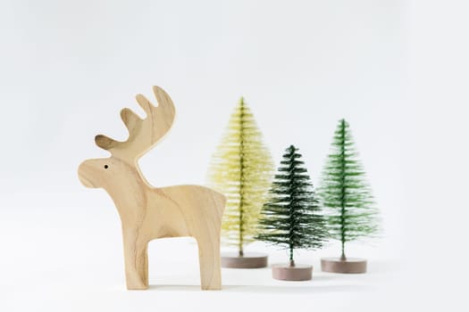 Christmas winter festive ornament. Reindeer and pine tree decoration on white background. Minimal holiday greeting season. Merry Christmas and Happy New Year.