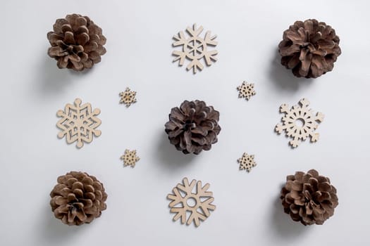 Christmas winter festive ornament. Christmas snowflakes decoration, pine trees and bells on white background. Christmas holiday decoration. Minimal holiday greeting season. Flat lay, top view.
