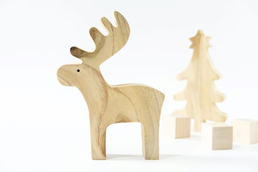 Christmas winter festive ornament. Wooden reindeer, pine tree and gift boxes decoration on white background. Christmas holiday party decoration. Minimal holiday greeting season.