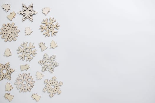 Christmas winter festive ornament. Christmas snowflakes decoration, pine trees and bells on white background. Christmas holiday decoration. Minimal holiday greeting season. Flat lay, top view.