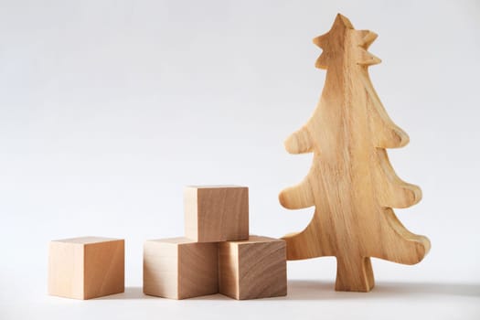 Christmas winter festive ornament. Wooden pine tree and gift boxes decoration on white background. Christmas holiday party decoration. Minimal holiday greeting season. Panoramic banner.