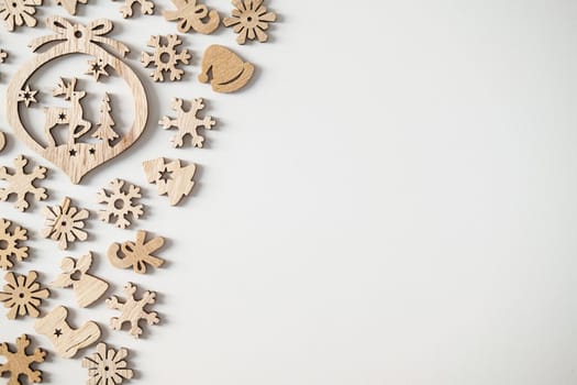 Christmas winter festive ornament. Wooden Christmas decoration on white background. Christmas holiday party decoration. Minimal holiday greeting season. Selective focus.