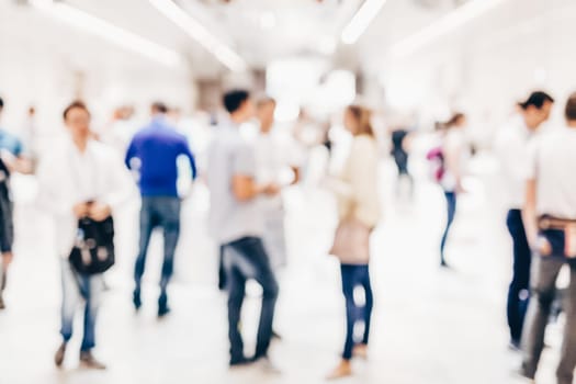 Abstract blurred people socializing during coffee break at business meeting or conference.
