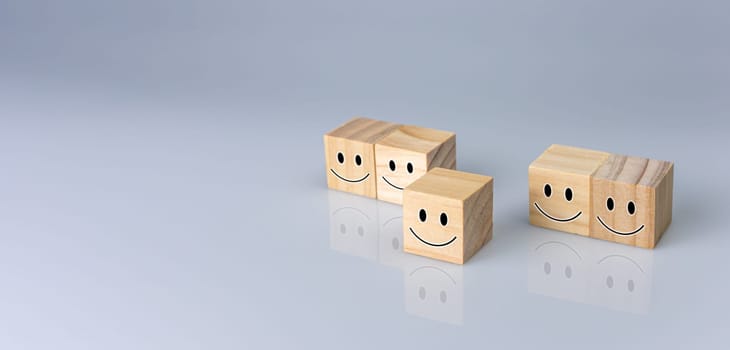Smiles on the cube. It represents positive ratings, feedback and customer reviews. Satisfaction Concept, Satisfaction Survey, Mental Health Assessment, Positive Thinking Concept.