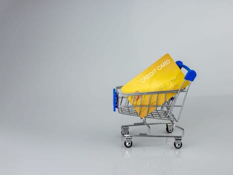 Shopping car and mockup credit card  on light and shadow background. shopping online concept.