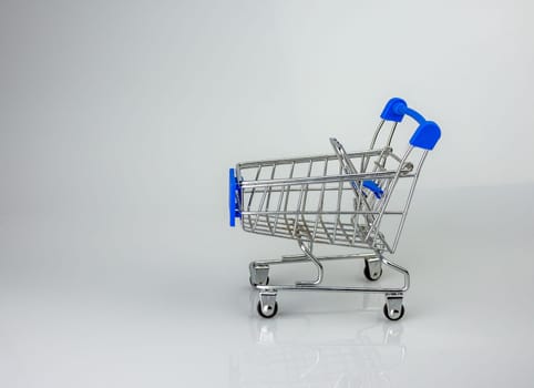 Shopping cart on white background with light and shadow. schopping concept.