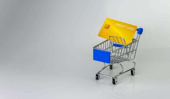 Shopping car and mockup credit card  on light and shadow background. shopping online concept.