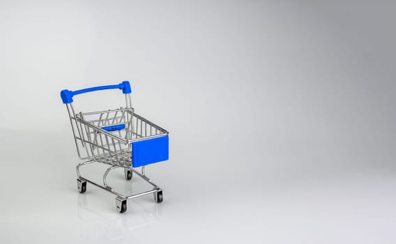 Shopping cart on white background with light and shadow. schopping concept.
