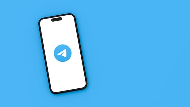 Telegram Logo on Mobile Phone Screen on Flat Blue Background with Copy Space 3D Render Illustration, Top View
